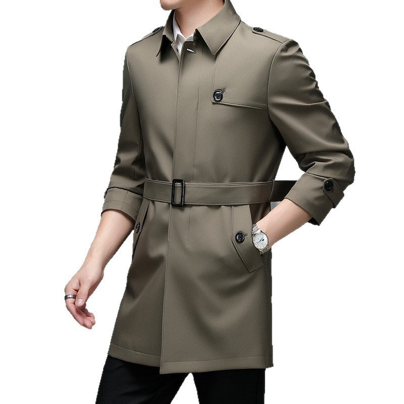 Green trench coat worn by a person on a white background